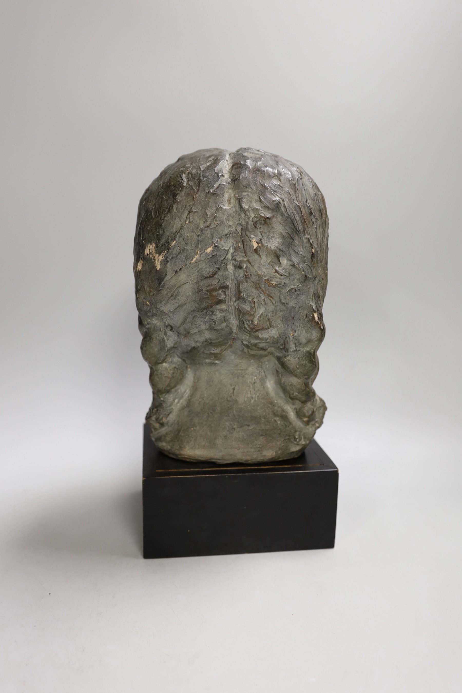 A terracotta bust of a girl on mount. 29cm tall overall